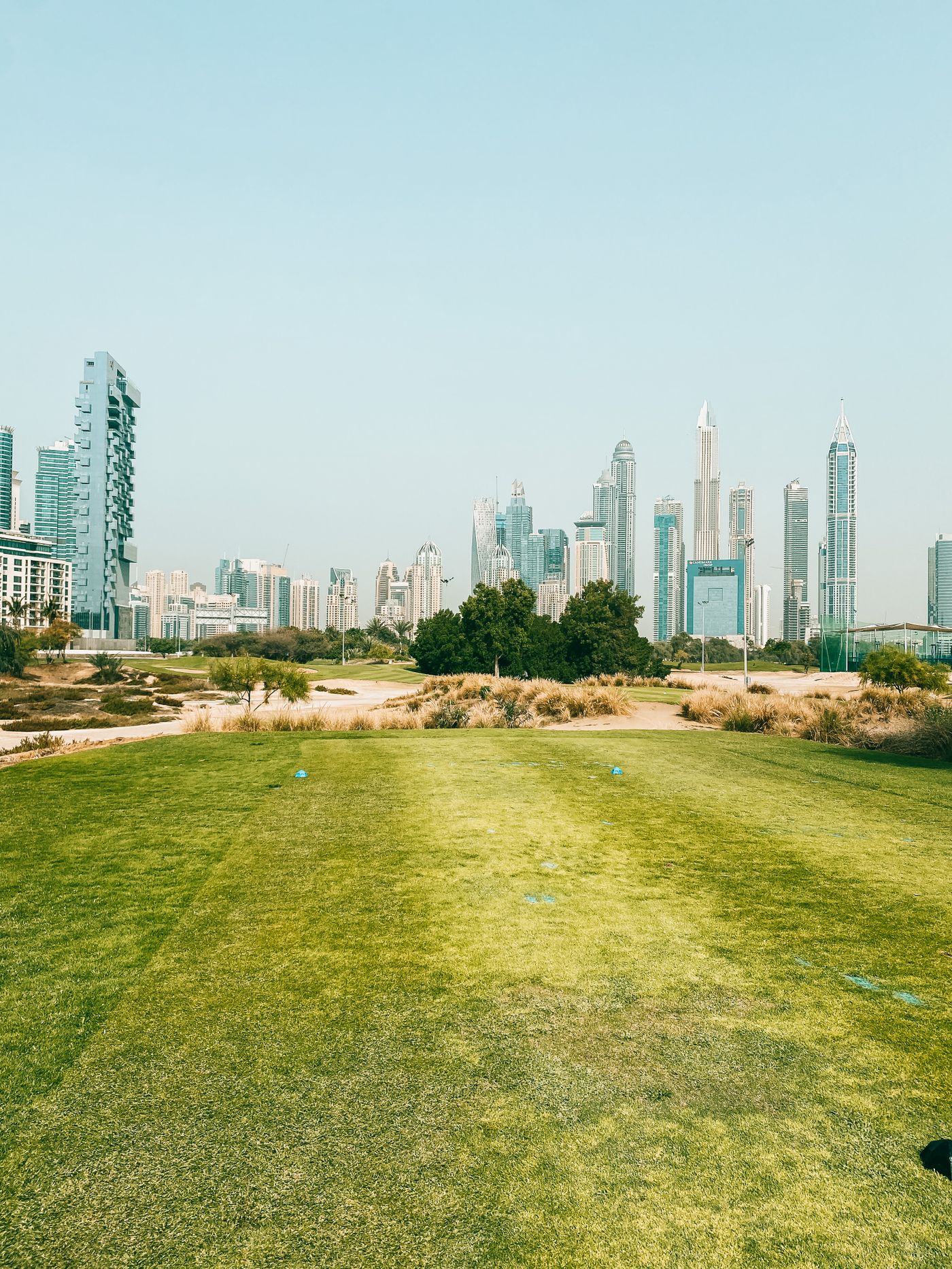 Emirates Golf Club fairway with Dubai Marina skyline