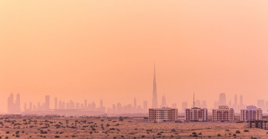 The Dubai skyline seen from the desert at sunrise