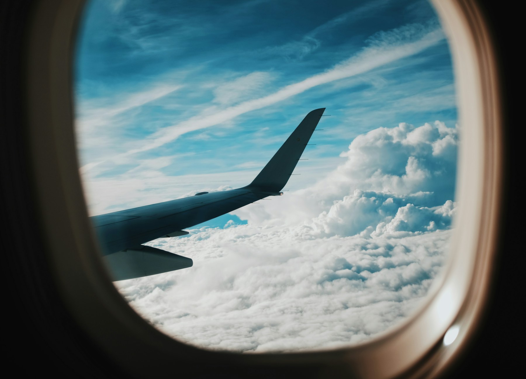 View from an aircraft window above the clouds