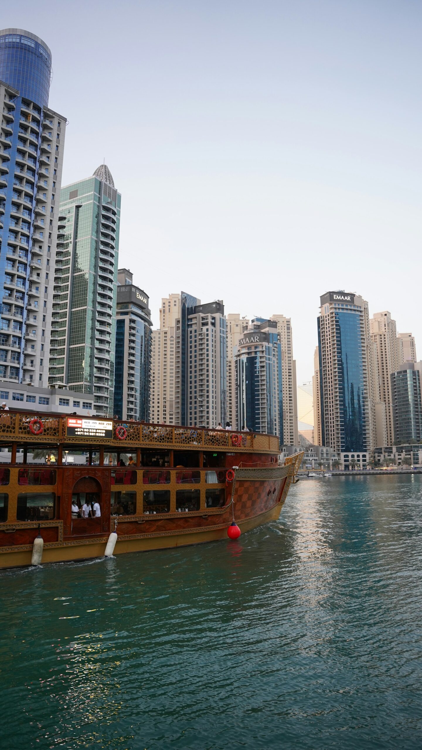 Traditional dhow passing the towers of Dubai Marina