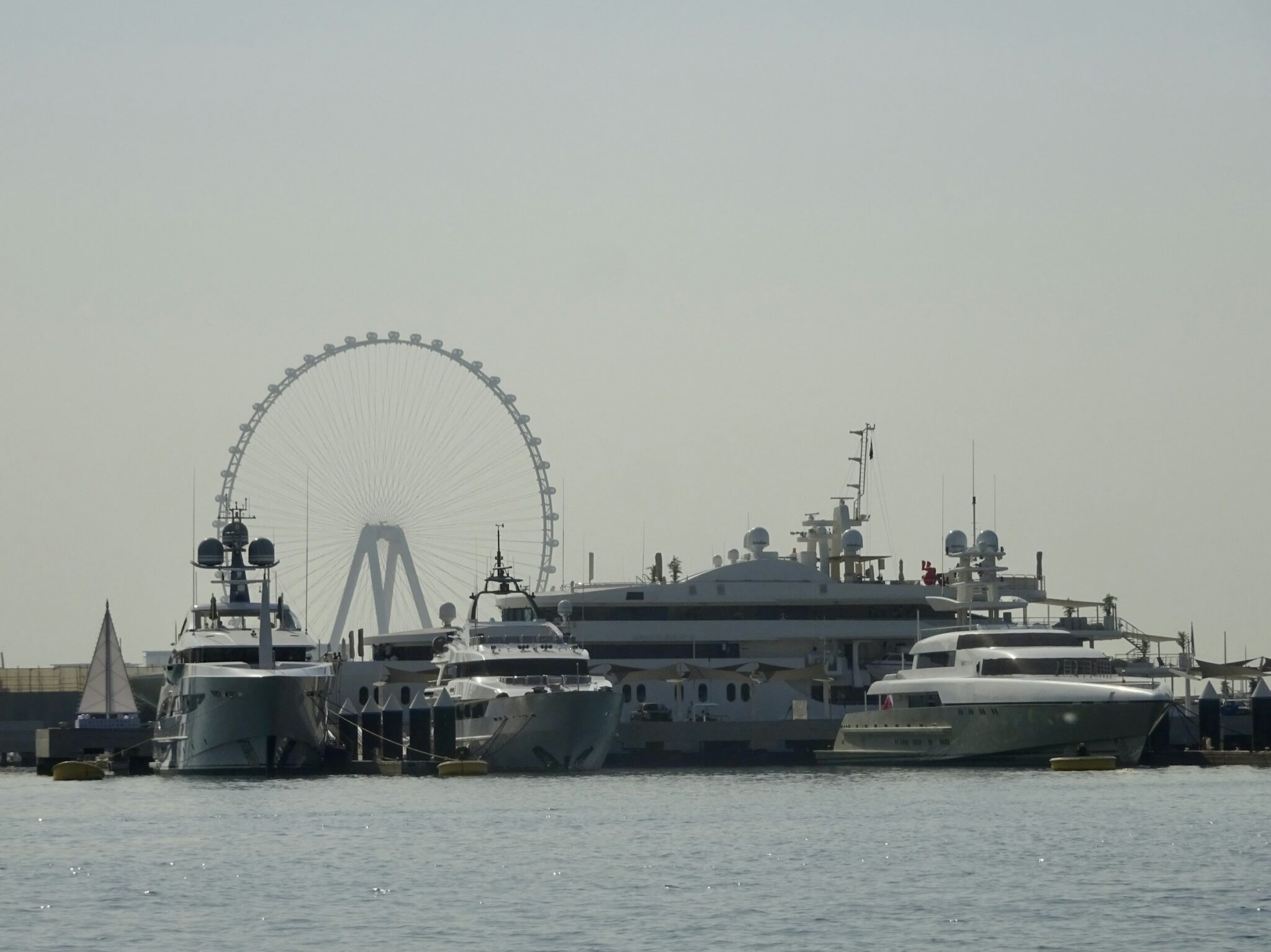 Yachts on the water with Ain Dubai beyond