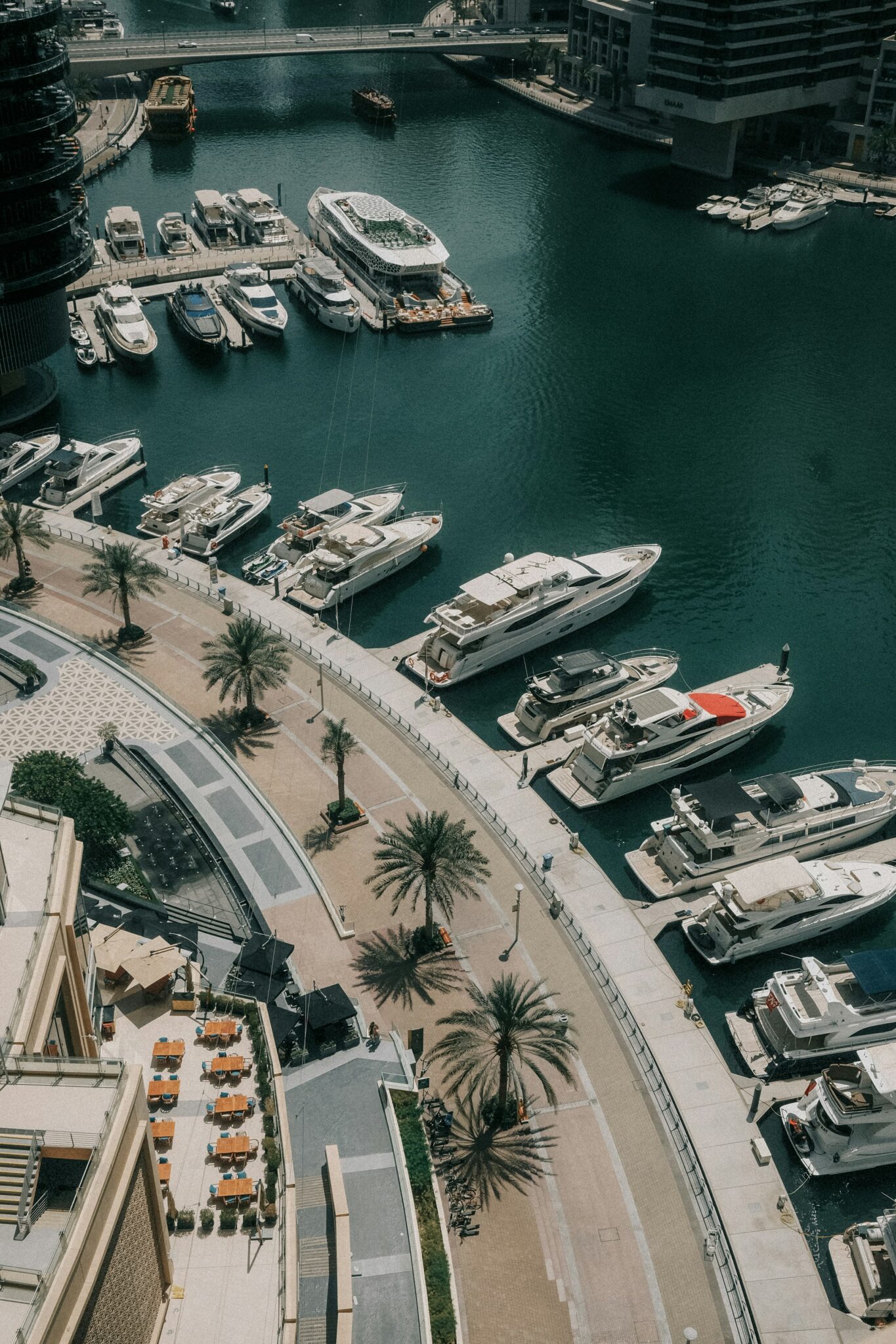 Yachts moored beside the Dubai Marina Walk promenade, from above